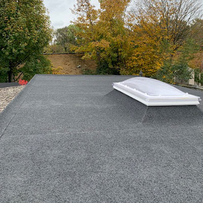 Felt flat roof installed for a business with a skylight.